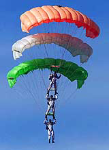 Paratroopers use parachutes in the colours of the National Flag during a display on the golden jubilee of the Army's only Parachute Regiment in Bangalore