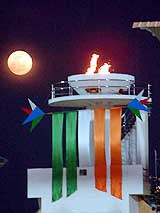 A view of full moon over the flames of the 32nd National Games torch