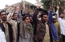 Friends and members of family protest against the arrest of nine persons at Mananwan village near Lahore