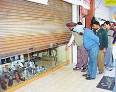 Shopkeepers of Phase VII, SAS Nagar, at the shoe store in the market where thieves struck in the wee hours of Saturday.