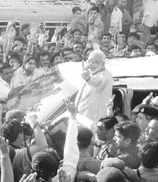 Mr Narendra Modi along with his supporters showing the victory sign in Ahmedabad.