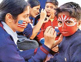 Students paint faces during the annual fete of Tender Heart School