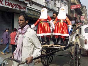 A shopkeeper carries Santa Claus