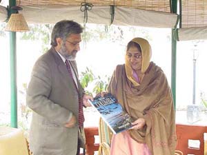 Mr Gulzar Cheema, State Minister for Health Services, British Columbia (Canada), presents a book