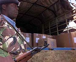 A Kenyan policeman guards a truck