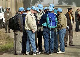 Members of a UN biological team search a baby milk factory in Abu Gharieb, about 25 km west of Baghdad