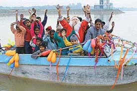 Slum children enjoy a CITCO-sponsored motorboat ride with Santa Claus on Christmas eve in Chandigarh