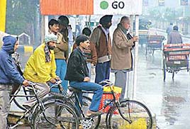 People look for shelter as the city experienced light showers that dipped the mercury 