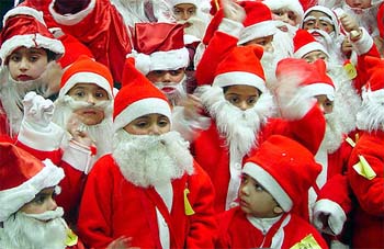 Children dress as Santa Claus during a gathering on Christmas eve in Amritsar on Tuesday