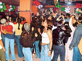 As the thumping beats filled the air, city youngsters twirled around the illuminated dance floor 