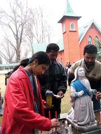 A Christian girl lights candles during special prayers in the Holy Family Church in Srinagar on the occasion of Christmas on Wednesday