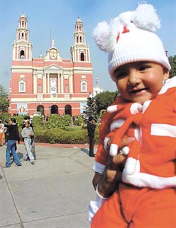 A child Santa comes calling at the Gol Dakkhana church 