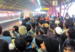 The scramble for the Metro train at Tis Hazari station in the Capital
