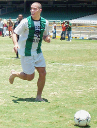 Playing barefooted Real Madrid�s Brazilian soccer star Ronaldo Nazario controls the ball during a match with his friends 