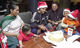 Indian cricket team captain Sourav Ganguly cuts a cake of Xmas