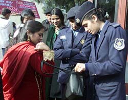Policewomen check a woman�s purse outside a church on the occasion of Christmas in Islamabad on Wednesday.