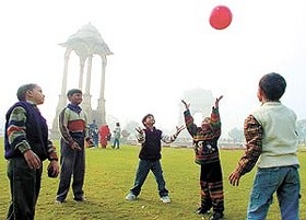 Children making merry on the India Gate lawn in the fog