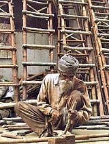 A carpenter makes ladders out of bamboo
