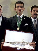 Morocco's Hicham El Guerrouj, 1500-meter world champion, holds his Merit Award