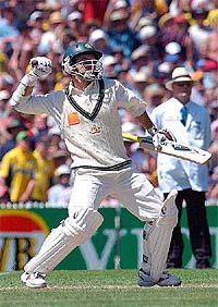 Australian batsman Justin Langer celebrates his century