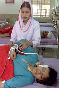 A nurse tends to a woman injured in the attack on a Christian church