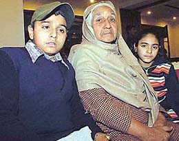 The two children, who have been adopted by the Niharika Ladies Club for education, with their grandmother 