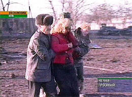 Injured people are seen making their way