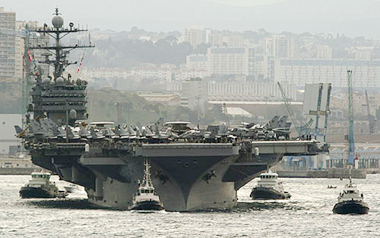 The USS Harry S Truman aircraft carrier, surrounded by French tugboats, leaves the harbour of Marseille, on Friday. 