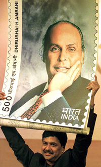 Information and Technology Minister Pramod Mahajan holds a mock stamp