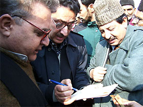 Jammu and Kashmir Minister Peerzada Mohammad Syed, right, with other supporters of the Congress party celebrate 118th anniversary of their party