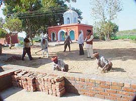 A memorial to ancestors being raised in Otalan village near Samrala.