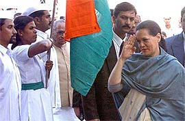 Congress President Sonia Gandhi returns the salute to Sewa Dal workers at the party foundation day celebrations at AICC headquarters in New Delhi
