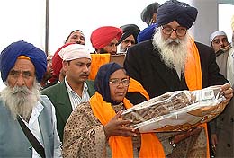 Former Chief Minister Parkash Singh Badal honours the SGPC members