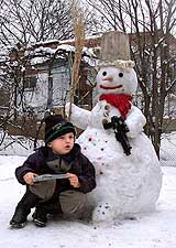 Four-year-old Chechen boy Samhan Matayev sits at the snowman