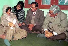 Chief Minister Mufti Mohammad Sayeed accompanied by senior party leaders, Tariq Hameed Kara and Mehbooba Mufti, talks to a militancy victim