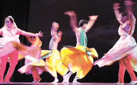 Swirling artistes of Urvashi Dance and Music Art & Cultural Society during a ballet