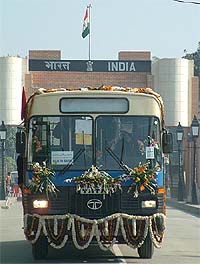 One of the 25 buses, donated by India to Afghanistan, crosses into Pakistan at Wagah checkpost on Sunday