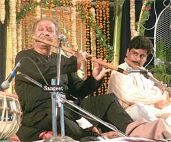 Flutist Hari Parsad Churasia performs during the 127th Harballabh Sangeet Sammelan in Jalandhar on Saturday