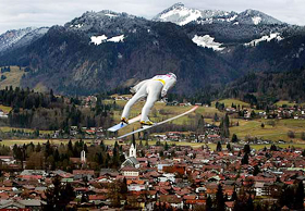 Sven Hannawald, Germany's ski jumping star, soars over the city of Oberstdorf
