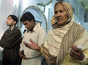 Pakistani Christians offer prayers during a Sunday service in a church in Rawalpindi