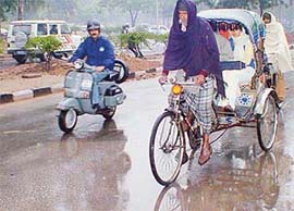 A rickshaw-puller has a tough time pulling his rickshaw in inclement weather in Chandigarh on Tuesday