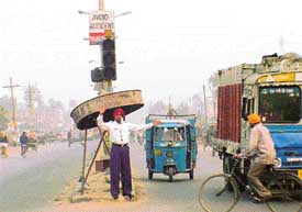 Despite the traffic lights having been installed at a national highway crossing in Khanna, policemen have to manage the traffic since lights usually remain out of order