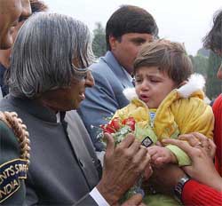 A boy presents a flower to greet President A.P.J. Abdul Kalam on New Year's Day 