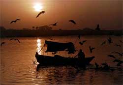 Sunrise at the confluence of the rivers Ganga, Yamuna and Saraswati 