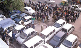 People milling around the car in which the blood-splattered body of a youth, Raman Katyal, was found in Connaught Place