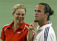 Belgium�s Kim Clijsters pulls the beard of doubles partner and compatriot Xavier Malisse 