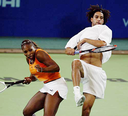 Serena Williams of the USA ducks for cover as team-mate James Blake smashes the ball over her 