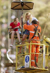 An emergency worker rescues two girls from the Arthur Seat chairlift on the Mornington Peninsula, 75 km southeast of Melbourne