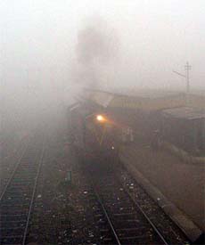 A train arrives at Rohtak station on Saturday morning with its headlight on. 