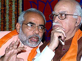 Deputy Prime Minister L.K. Advani (right) listens to Gujarat Chief Minister Narendra Modi during the BJP�s executive committee meeting in Gujarat 